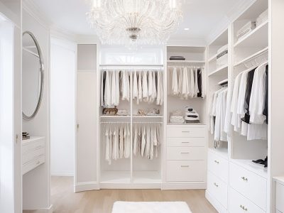 White luxury walk in closet interior with light frome the window